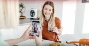 Content creator recording TikTok video to promote digital products online.