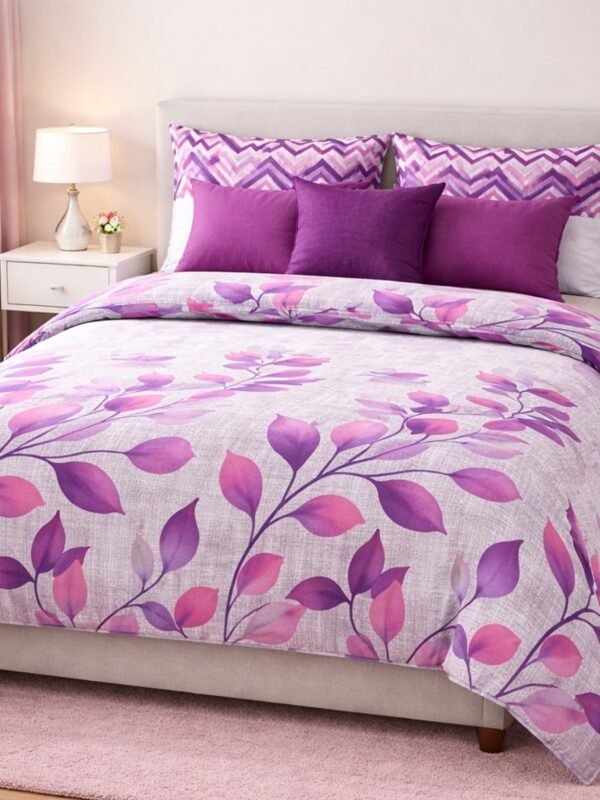 Abstract double bed bedsheet with pink leaf design styled on a modern bedroom bed with matching pillow covers.