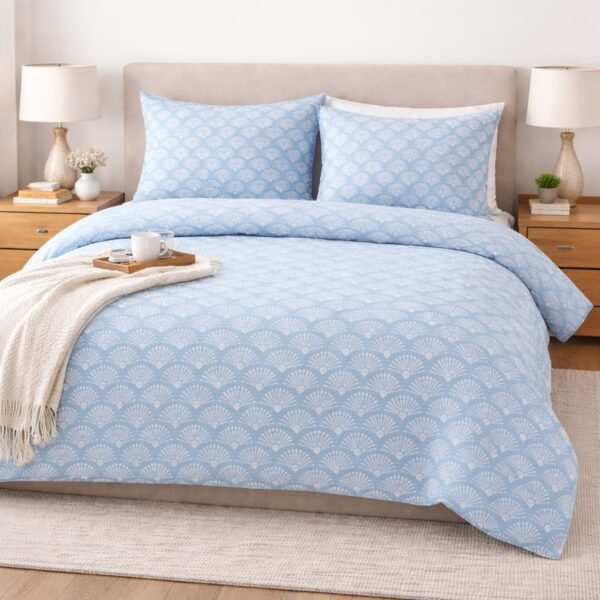 Blue printed double bed bedsheet with elegant fan pattern styled on a bed creating modern bedroom decor.