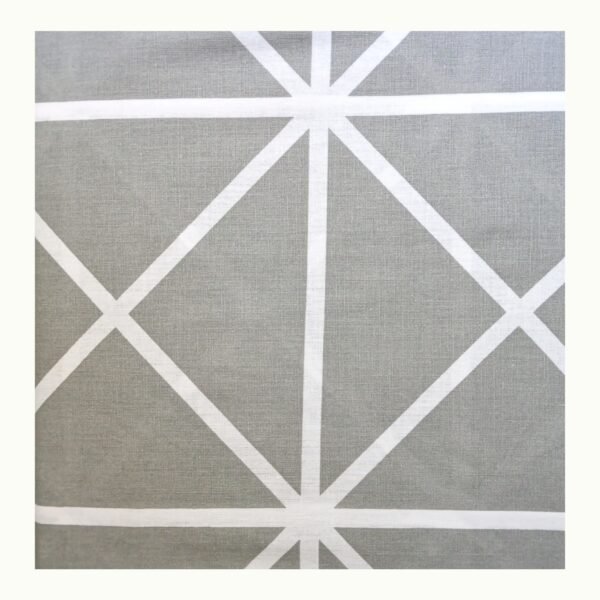 Closeup of printed double bed bedsheet set showing grey cotton blend fabric with white geometric line pattern.
