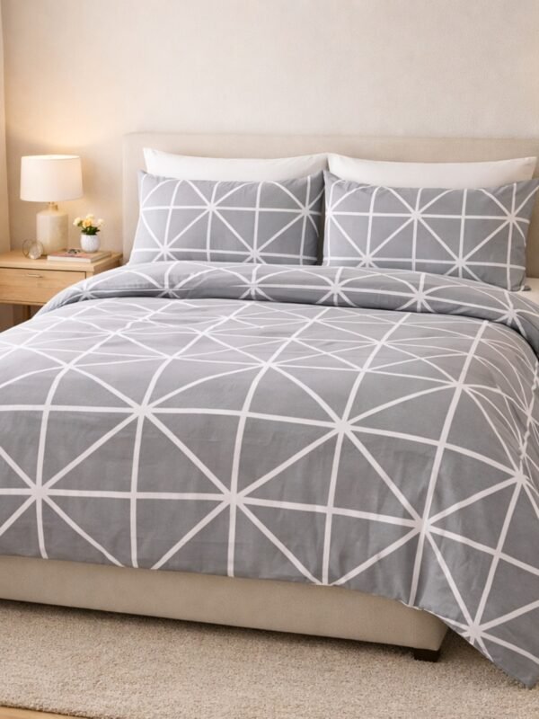 Printed double bed bedsheet set with modern grey geometric pattern styled on bed creating minimal and stylish bedroom decor.
